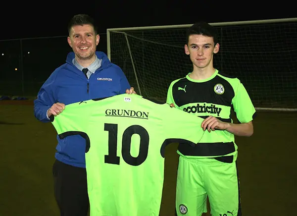 Anthony Foxlee-Brown, marketing communications manager proudly displays the Grundon sponsored kit