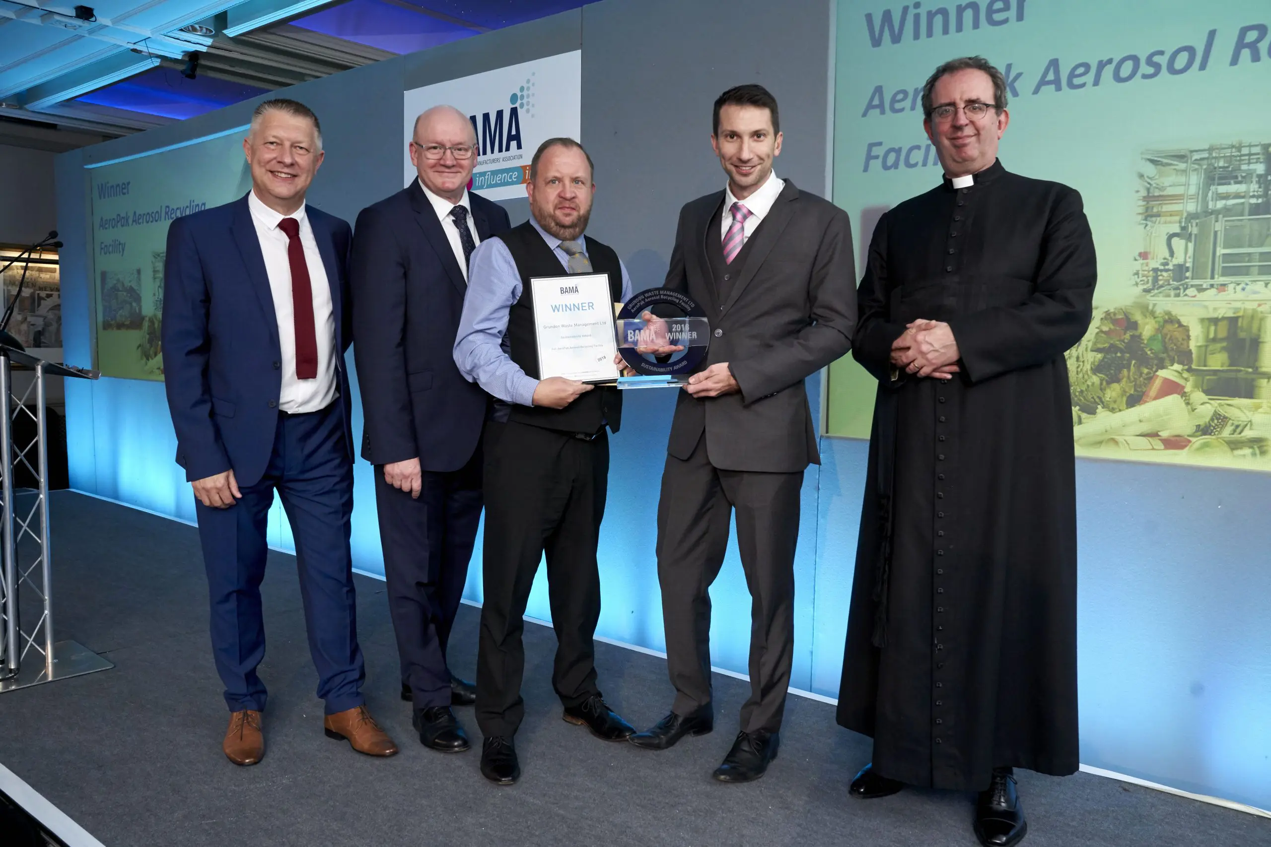 Grundon's Paul McConaghy and Tim Buxton celebrate winning the prestigious BAMA Sustainability Award 2018, which was presented to them by the Reverend Richard Coles.