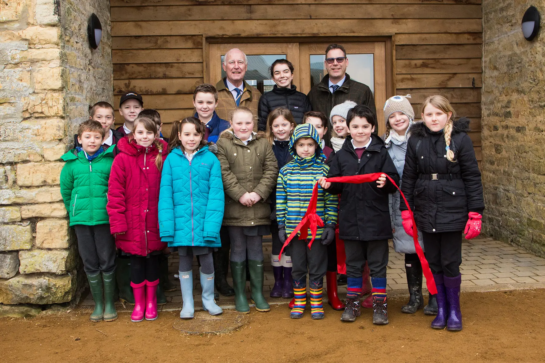Norman Grundon, Chairman of Grundon Waste Management (back left) and Neil Grundon, Deputy Chairman (back right) celebrate the opening of the new education centre at Greystones Farm with children from Bourton-on-the-Water Primary School.