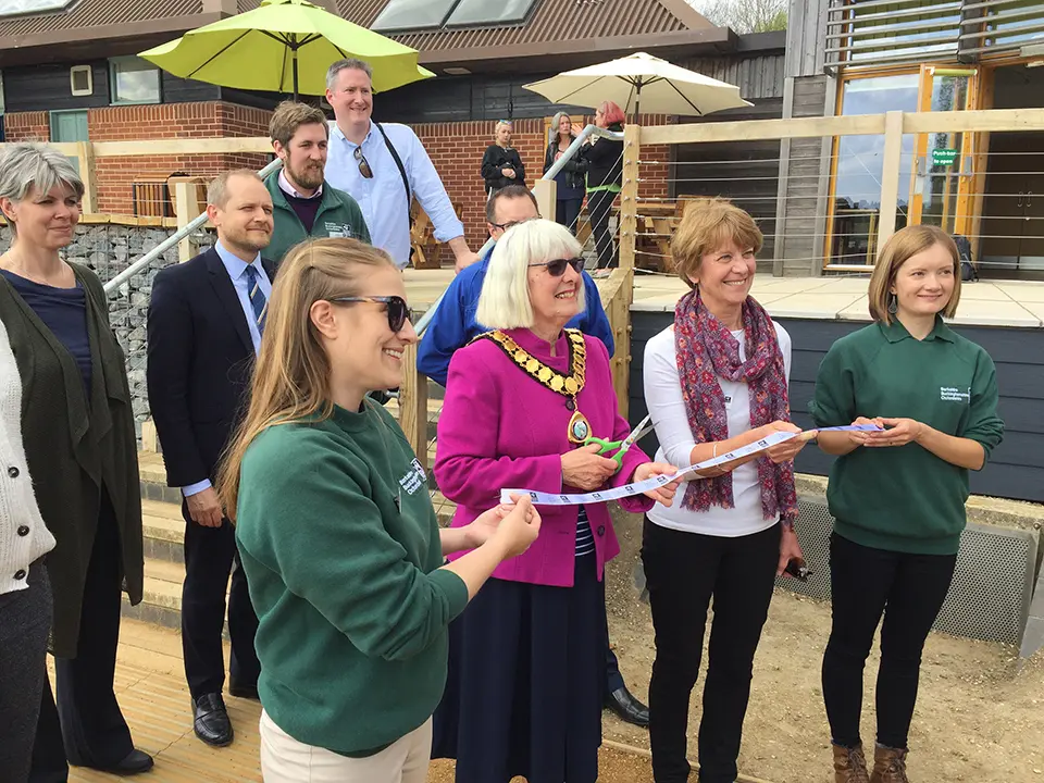 Councillor Jan Cover, Town Mayor of Thatcham 2018-19, prepares to cut the ribbon at the official opening, watched by BBOWT Chairman Barbara Muston (in white) and BBOWT staff, supporters and sponsors.