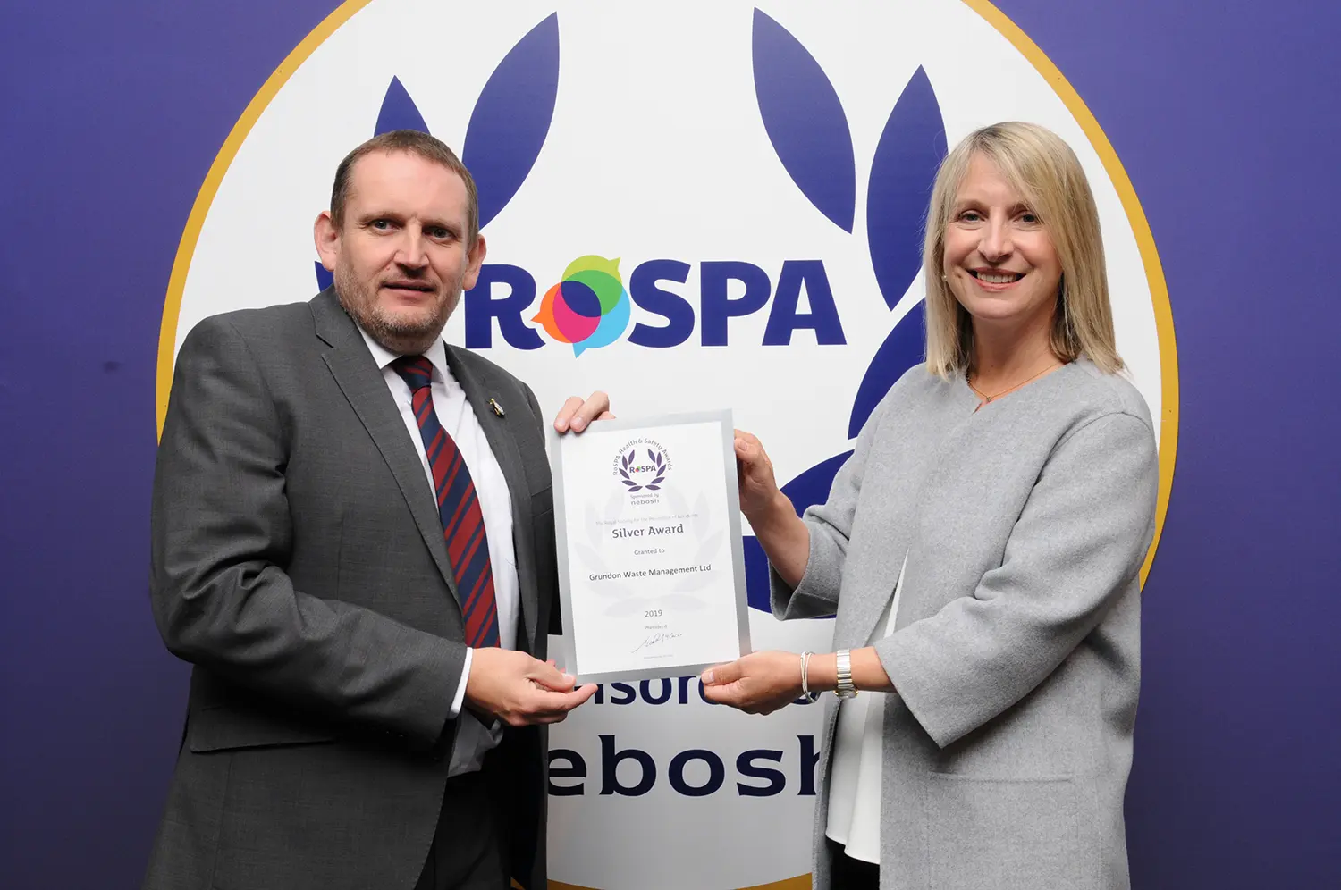Reg Hodson, SHEQ Manager at Grundon Waste Management, collects the Silver Award from Jocelyn McNulty, RoSPA Trustee, at the RoSPA 2019 Awards