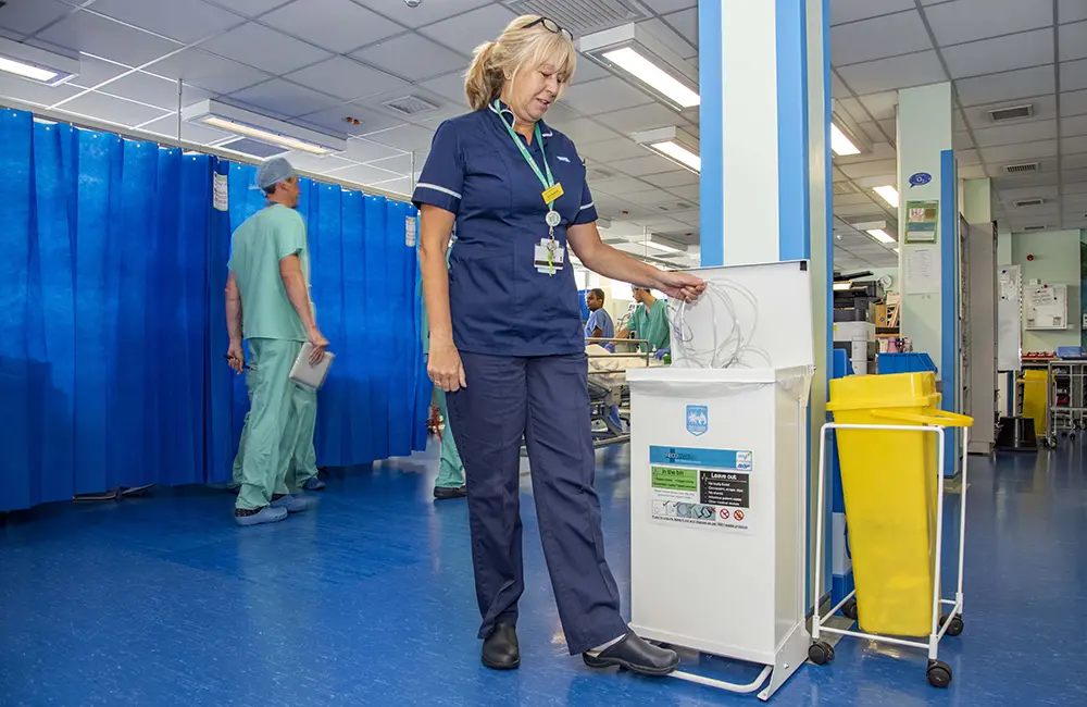 Sue Hardyman, Theatre Recovery Sister at Royal Berkshire Hospital using one of the RecoMed bins to recycle single-use medical PVC items