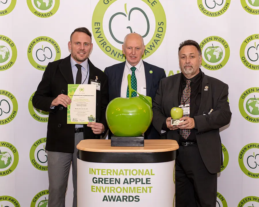 Grundon's Phil Steer, Commercial Manager – Clinical (left) and Steve Sellwood, Facilities Manager at the Royal Berkshire NHS Foundation Trust (right) collect the prestigious Gold Green Apple Award for Environmental Best Practice in the Wastes Management NHS and Healthcare category from Roger Wolens, Founder of The Green Apple Awards and Chief Executive Officer of The Green Organisation (centre)