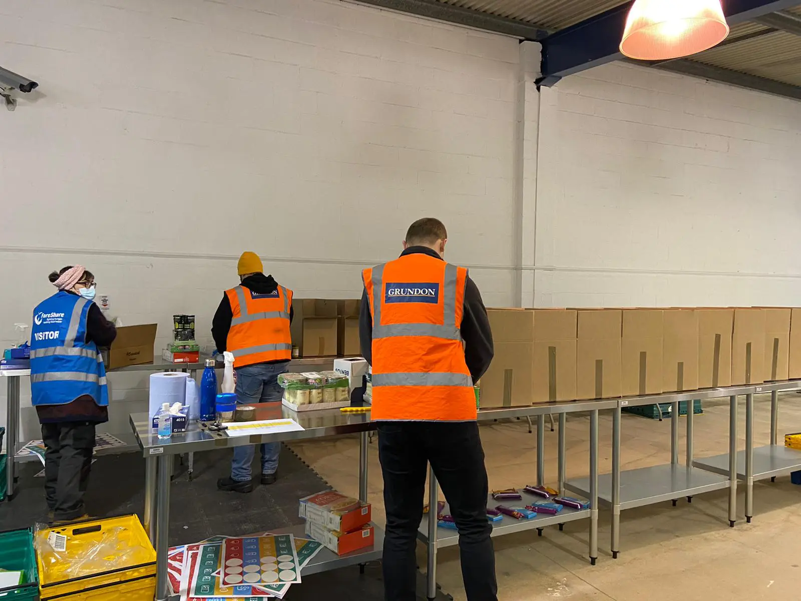 Members of the Grundon team pack food parcels ready for them to be distributed to the local community.