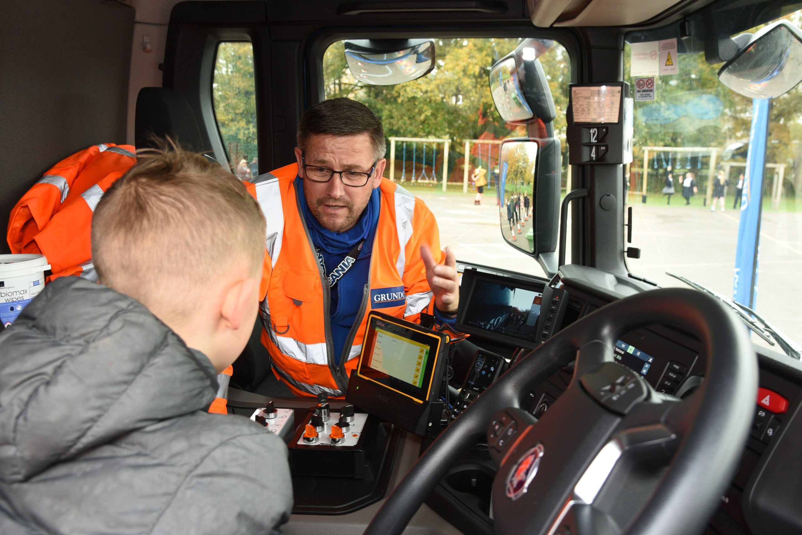 One Newbury pupil sits inside the cab as Paul Douglas, Transport Trainer at Grundon talked through the safety features