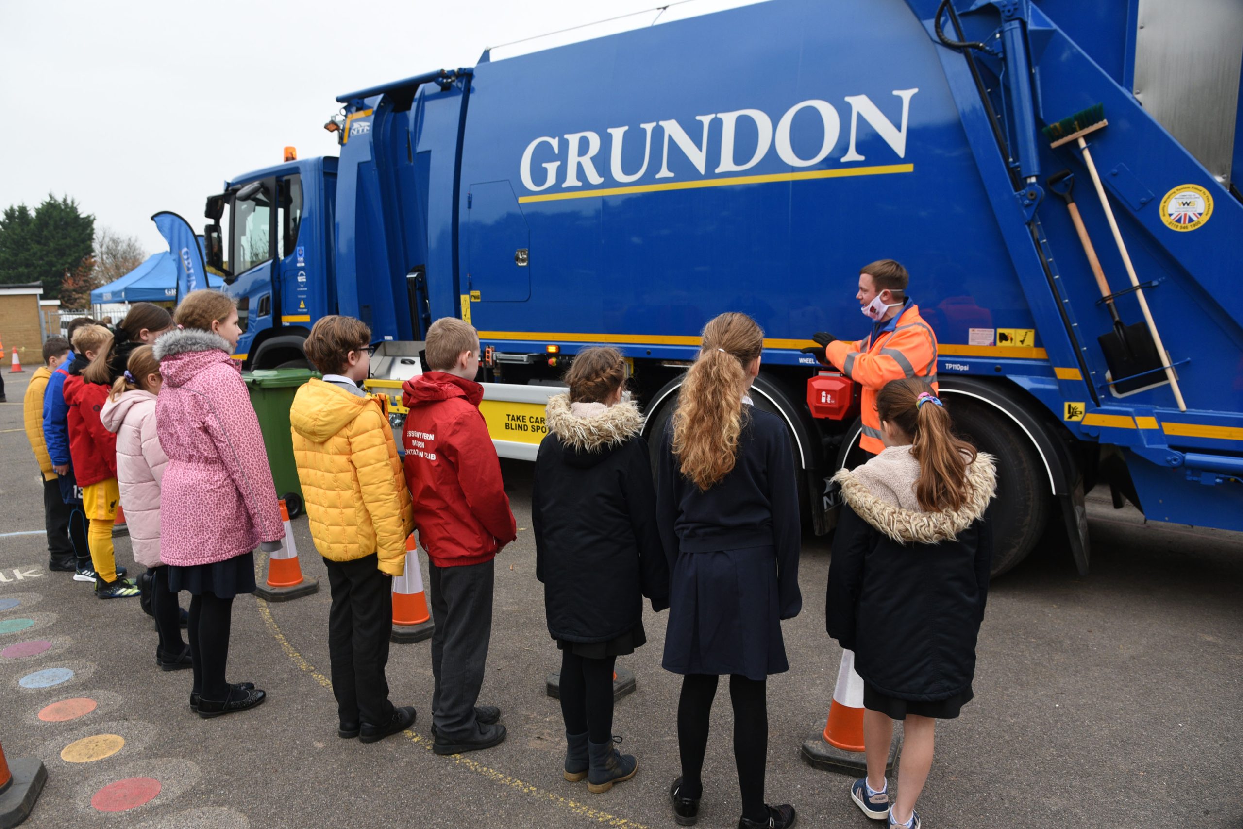 Paul Colling, Transport Trainer at Grundon explains some of the vehicle's safety features to pupils in Newbury
