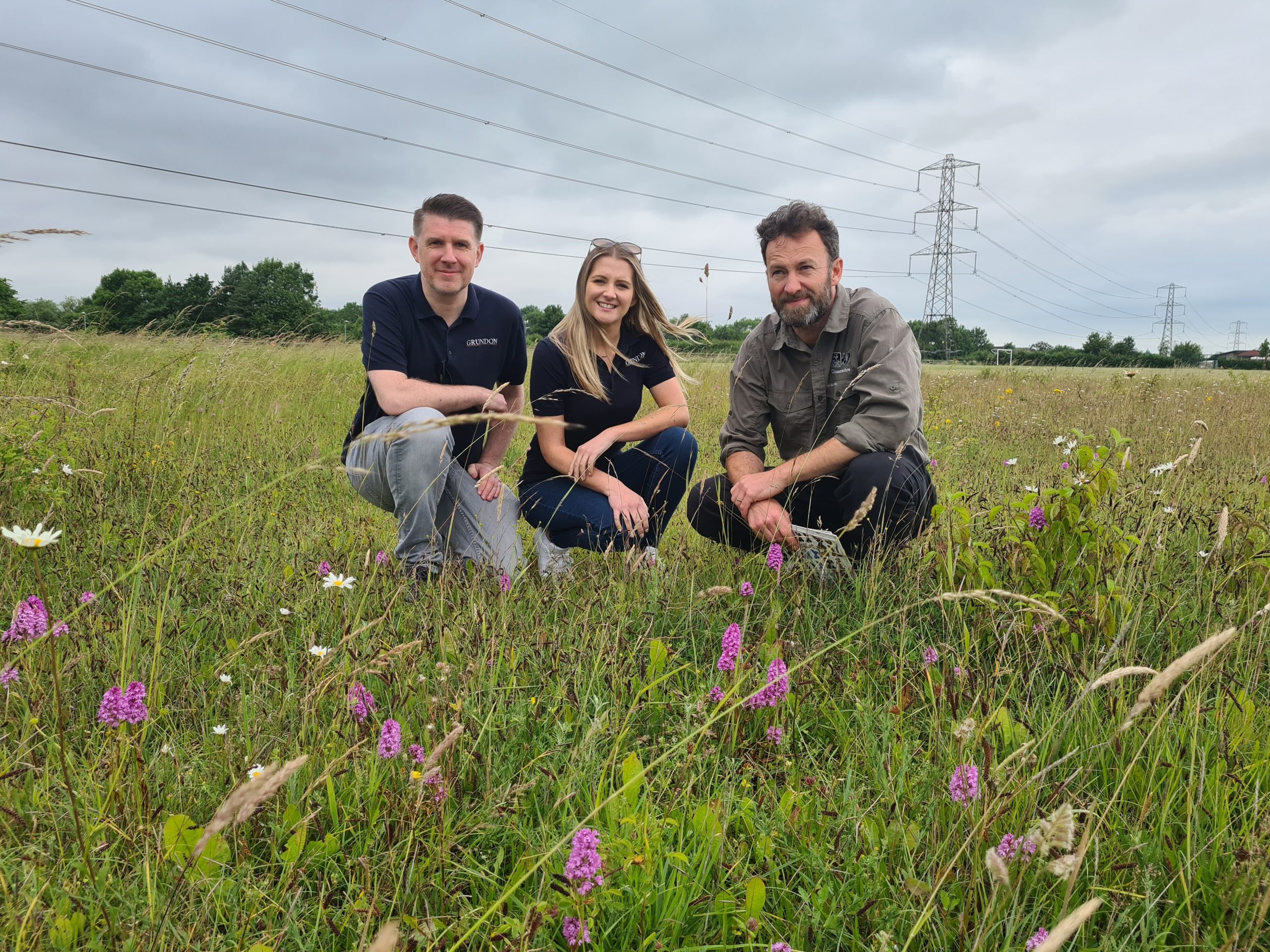 From left to right: Anthony Foxlee-Brown and Kirsti Santer of Grundon and Will Masefield, Project Manager at Gloucestershire Wildlife Trust, look at the thriving orchid species which can now be found at Cirencester's Kingshill meadow, one of seven locations around the town which have benefitted from funding worth £25,000 via the Landfill Communities Fund.