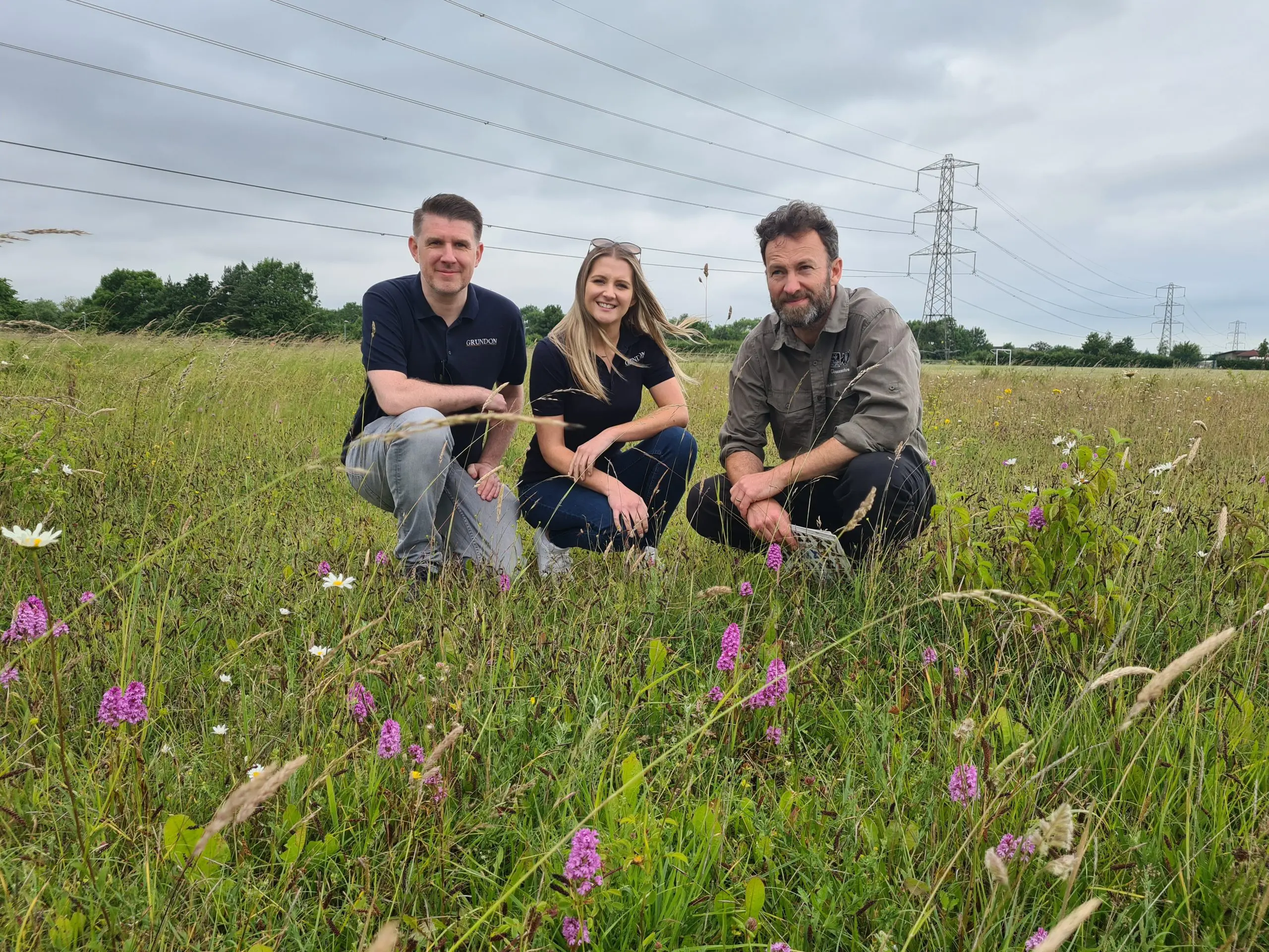 From left to right: Anthony Foxlee-Brown and Kirsti Santer of Grundon and Will Masefield, Project Manager at Gloucestershire Wildlife Trust, look at the thriving orchid species which can now be found at Cirencester's Kingshill meadow, one of seven locations around the town which have benefitted from funding worth £25,000 via the Landfill Communities Fund.