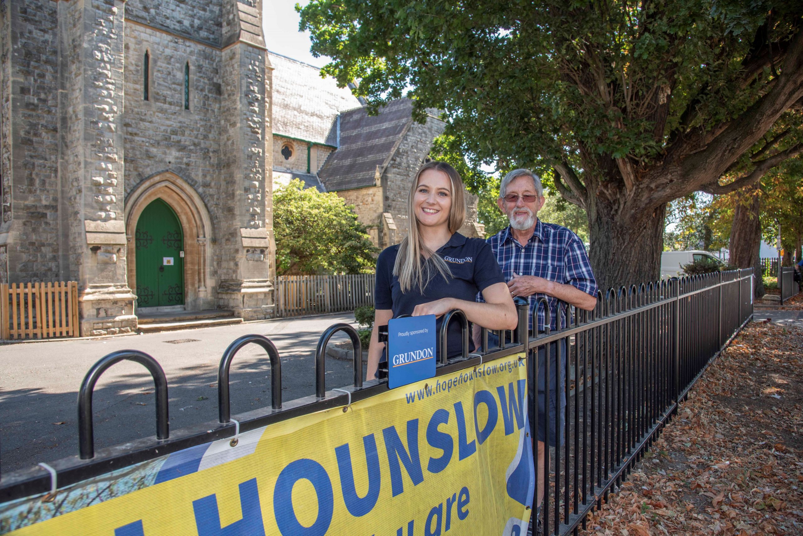 Kirsti Santer, from Grundon, and Graham Neilson, from Hope Church Hounslow, are pictured outside the church with the smart new fencing.