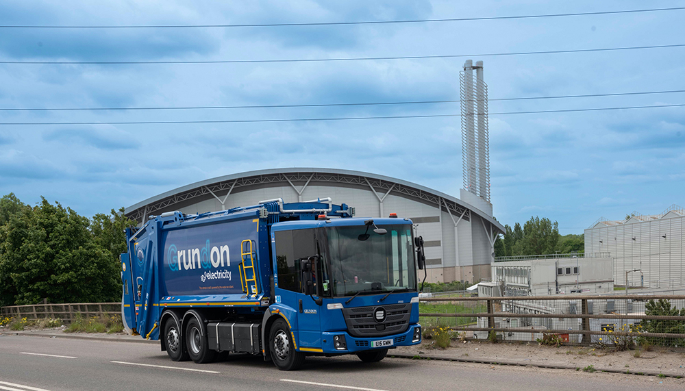 Grundon's new electric waste collection vehicle with the Lakeside Energy from Waste facility in the background
