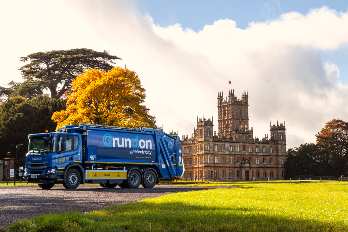 Electric vehicle pictured in front of Highclere Castle, one of Grundon's long standing customers