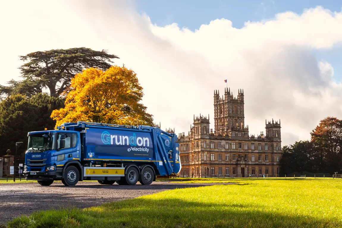 Electric vehicle pictured in front of Highclere Castle, one of Grundon's long standing customers 