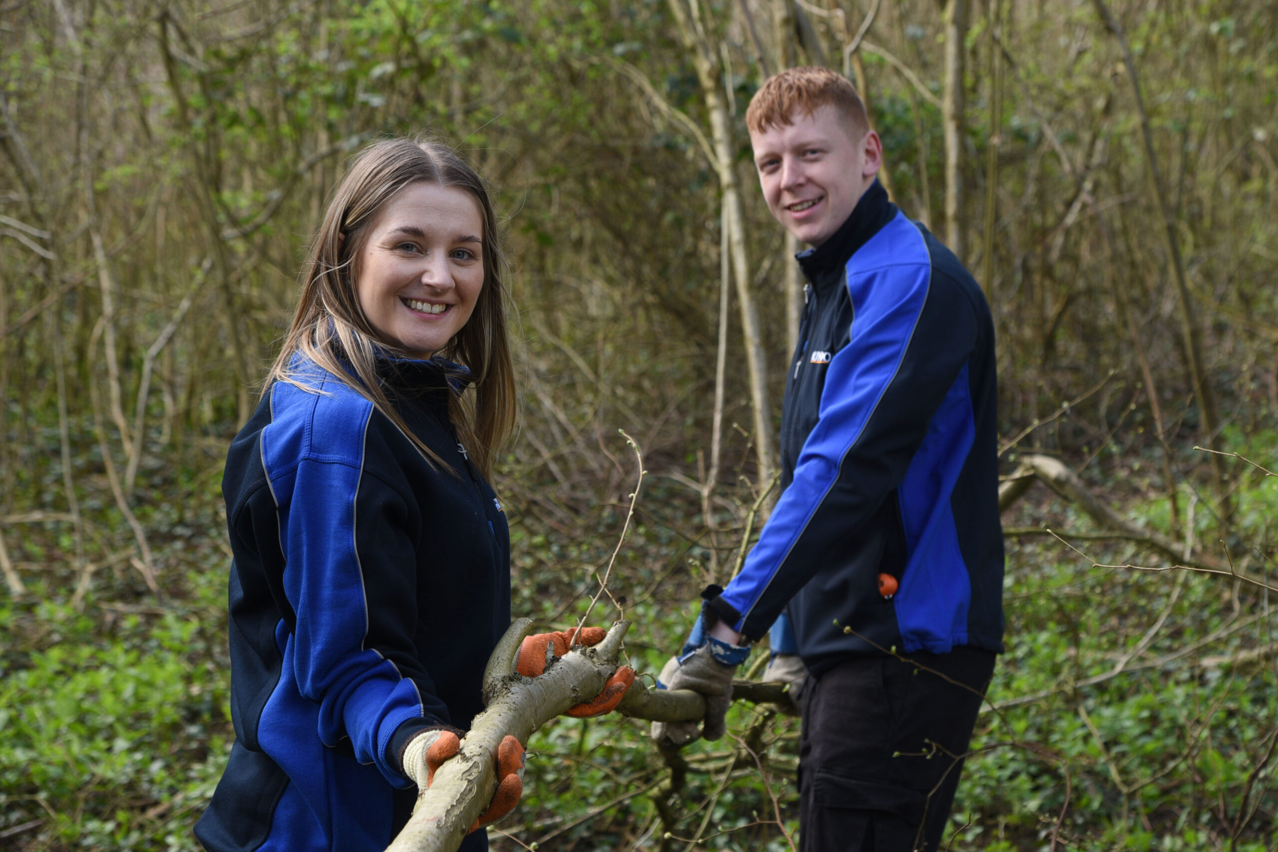 Grundon's Kirsti Santer and Harry Bond get to grips with coppicing on their volunteer day at Woodoaks Farm