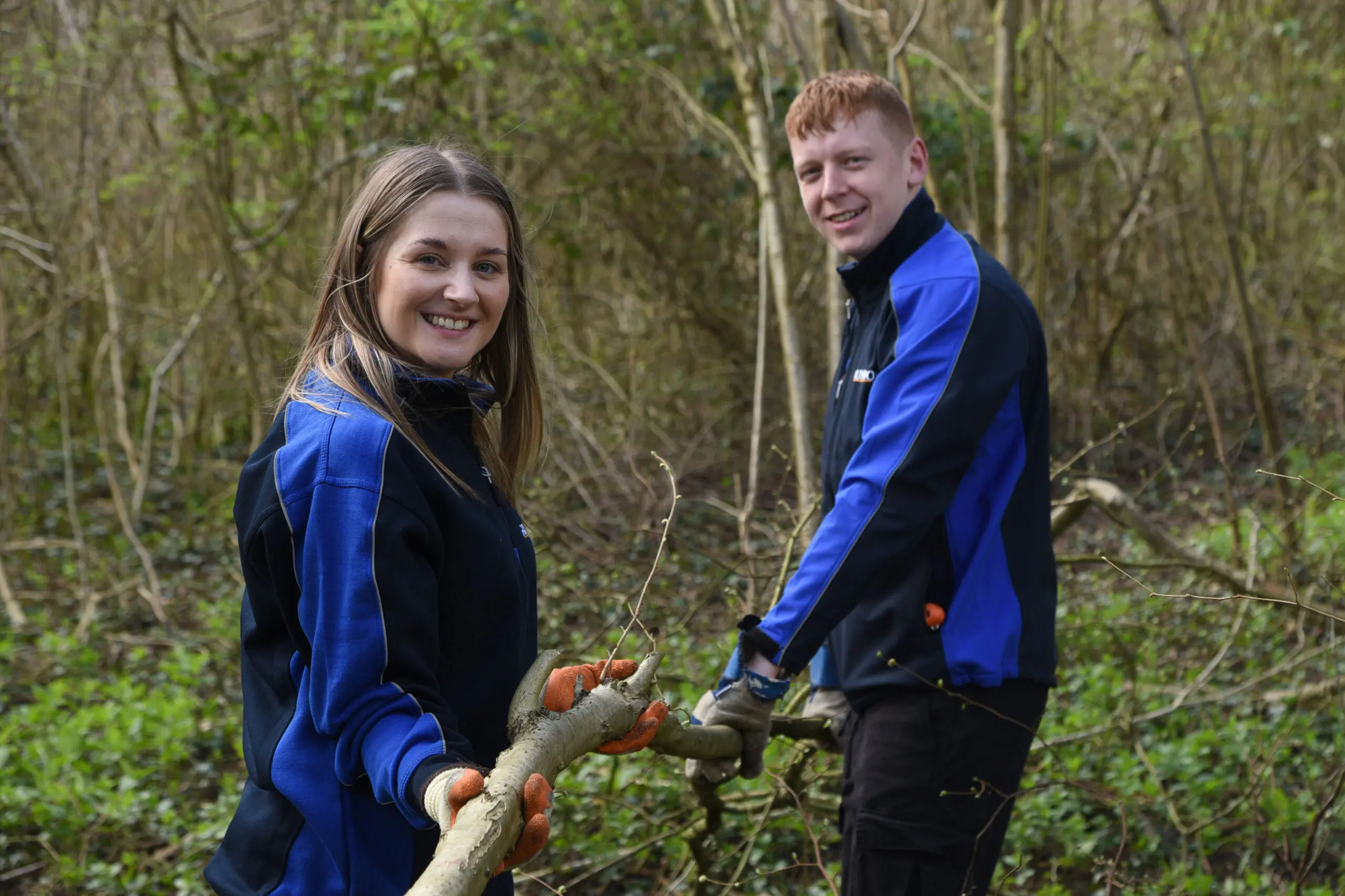 Grundon's Kirsti Santer and Harry Bond get to grips with coppicing on their volunteer day at Woodoaks Farm