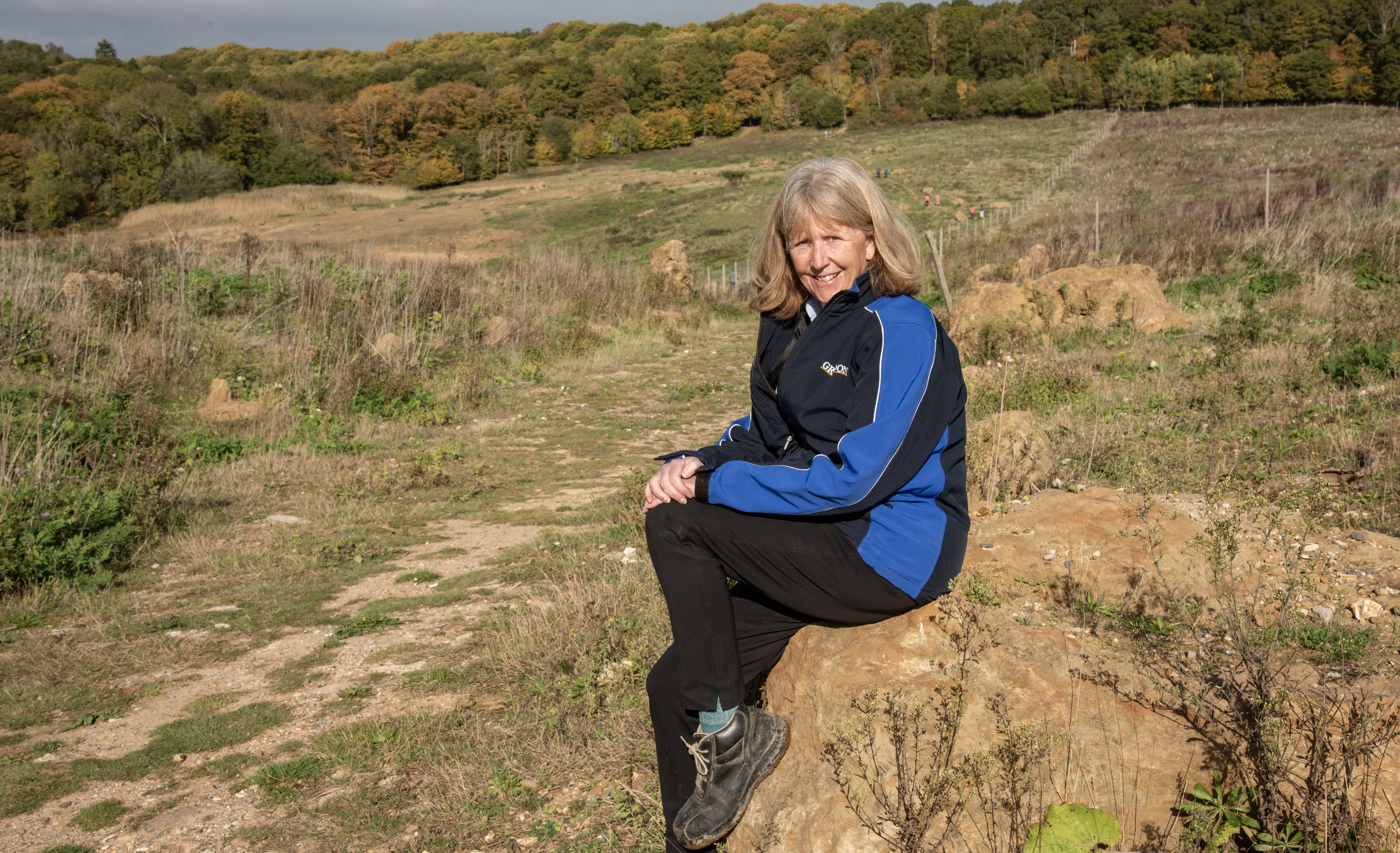 Toni Robinson takes a break to survey the way nature has reclaimed the restored landfill