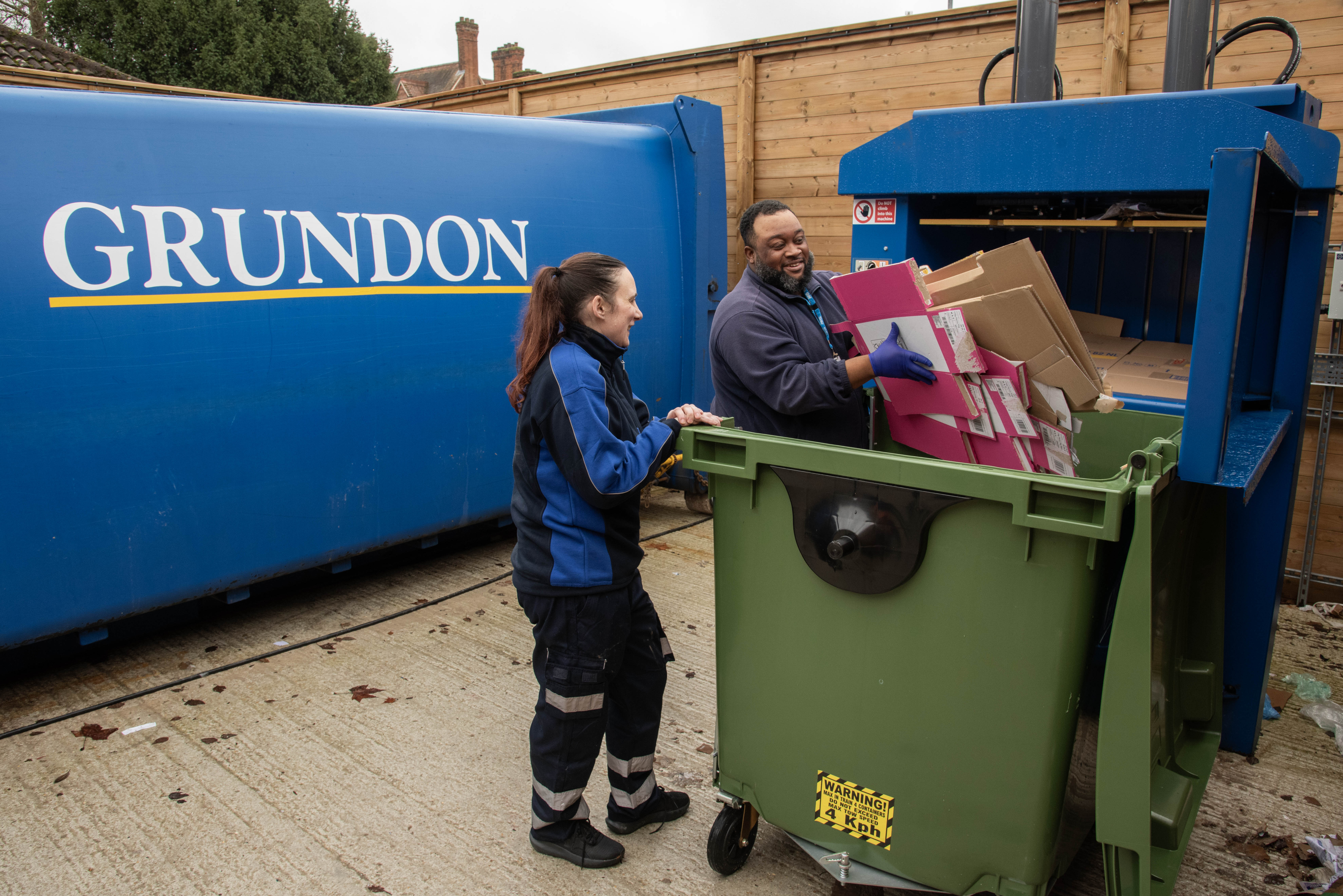 Chloe Mason (left) with Justin Edwards, Assistant Team Leader for Waste Services in the new dry waste yard baling the hospitals cardboard with the new baler